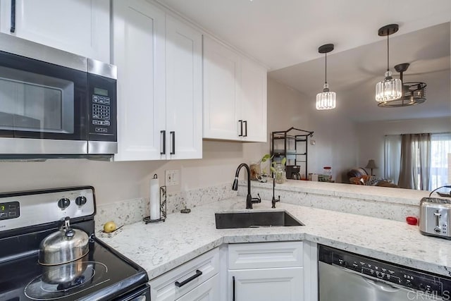 kitchen with light stone countertops, decorative light fixtures, white cabinetry, stainless steel appliances, and sink