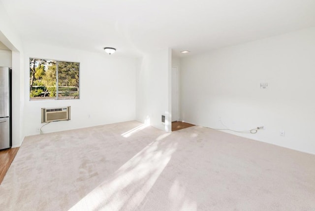 unfurnished room featuring an AC wall unit