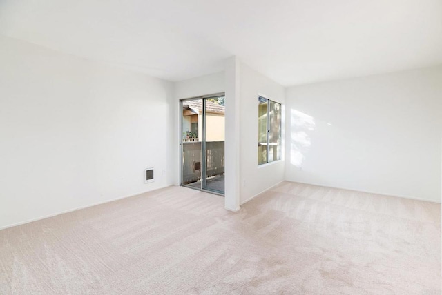 unfurnished room with light carpet