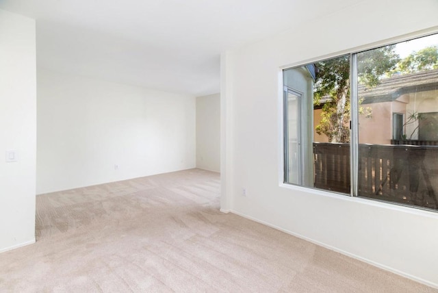 unfurnished room featuring light carpet