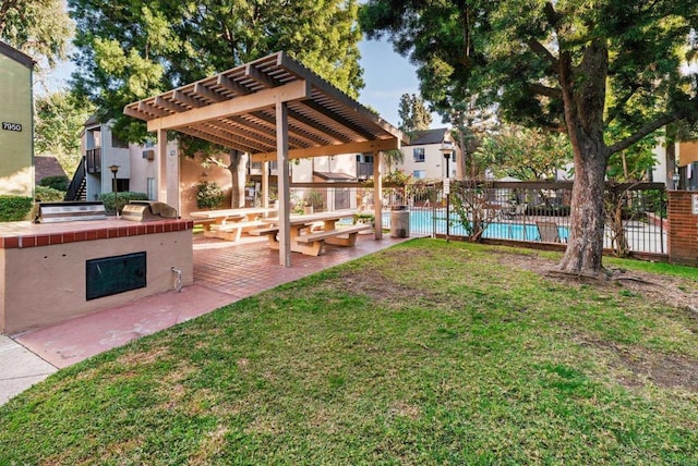 view of yard with a patio, a community pool, area for grilling, and a pergola