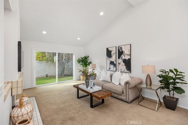 carpeted living room with high vaulted ceiling