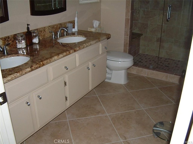 bathroom with tile patterned flooring, vanity, and an enclosed shower