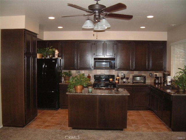 kitchen featuring light tile patterned flooring, sink, dark brown cabinets, a kitchen island, and black appliances