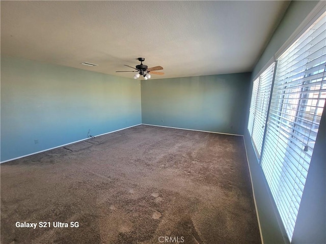 carpeted spare room with ceiling fan