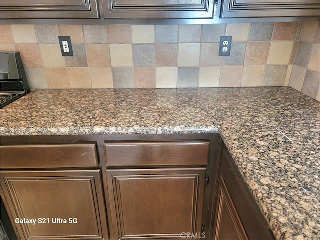 details with tasteful backsplash and gas stove