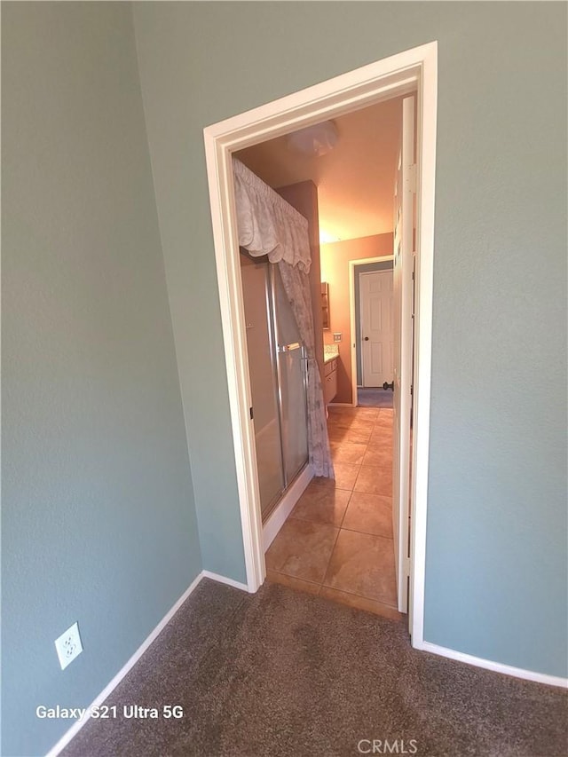 hallway featuring light colored carpet