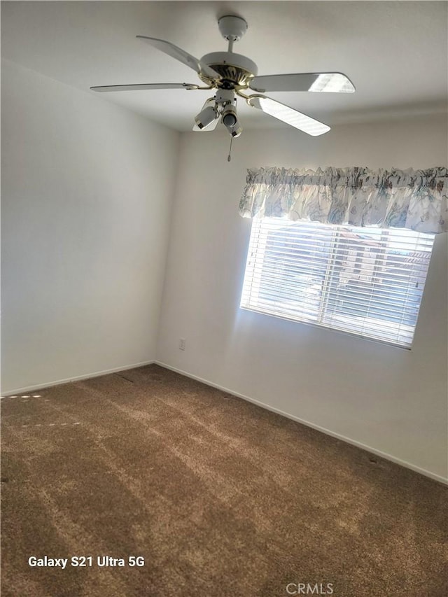 carpeted empty room featuring ceiling fan