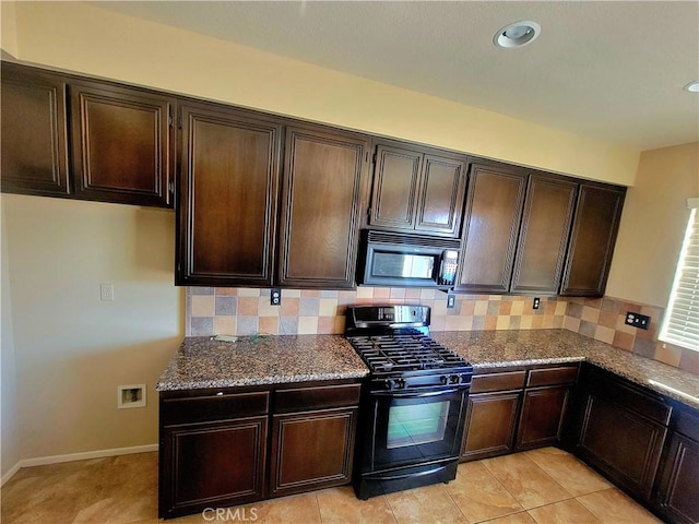 kitchen featuring tasteful backsplash, dark stone countertops, dark brown cabinetry, and black appliances