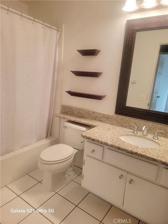 full bathroom with vanity, shower / tub combo with curtain, tile patterned floors, and toilet