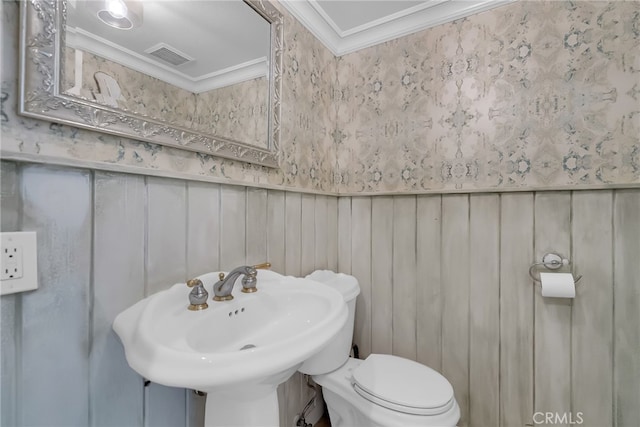 bathroom featuring crown molding, toilet, and sink