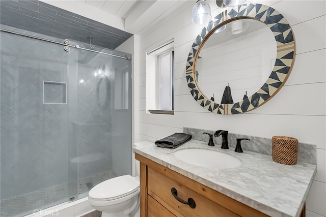 bathroom with an enclosed shower, vanity, and toilet