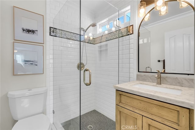 bathroom featuring crown molding, vanity, an enclosed shower, and toilet