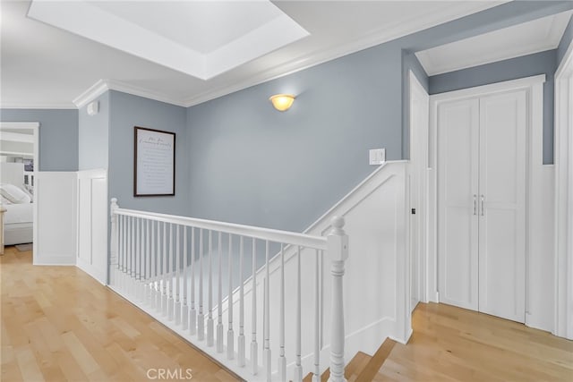 hall featuring hardwood / wood-style flooring and crown molding