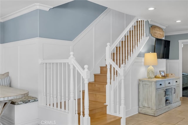 staircase featuring crown molding