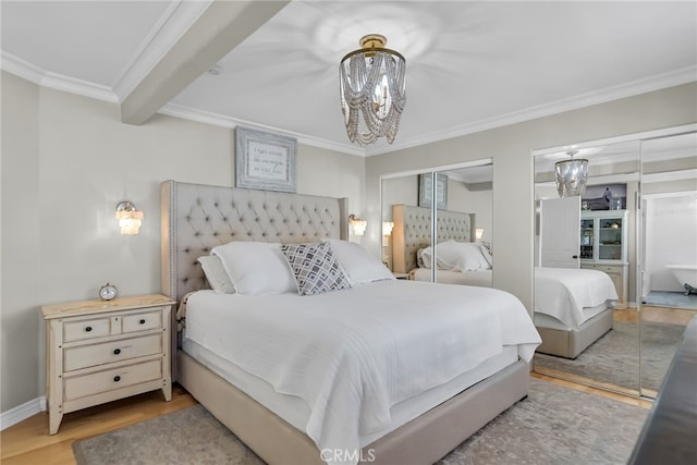 bedroom with hardwood / wood-style flooring, ornamental molding, beam ceiling, and a notable chandelier