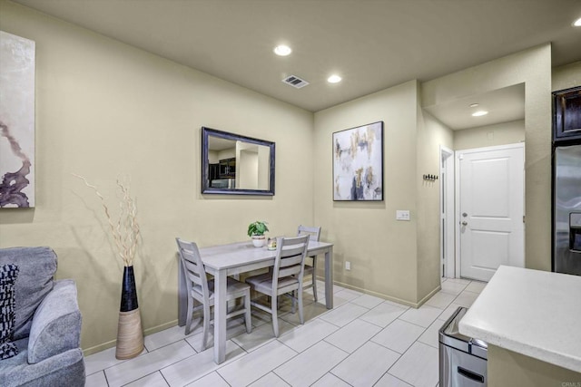 dining space with light tile patterned flooring