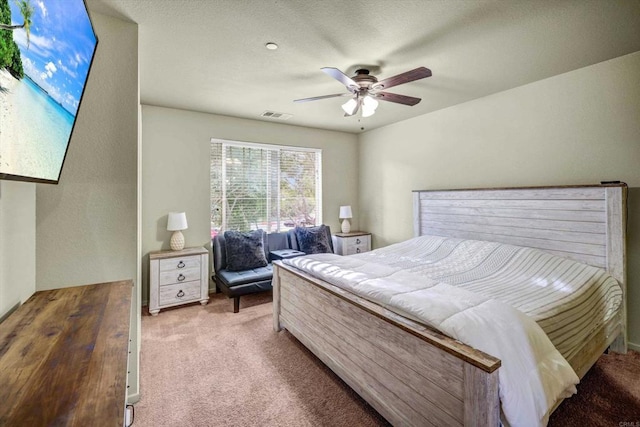 bedroom featuring ceiling fan and carpet