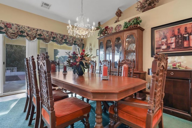 dining area with carpet, vaulted ceiling, and an inviting chandelier