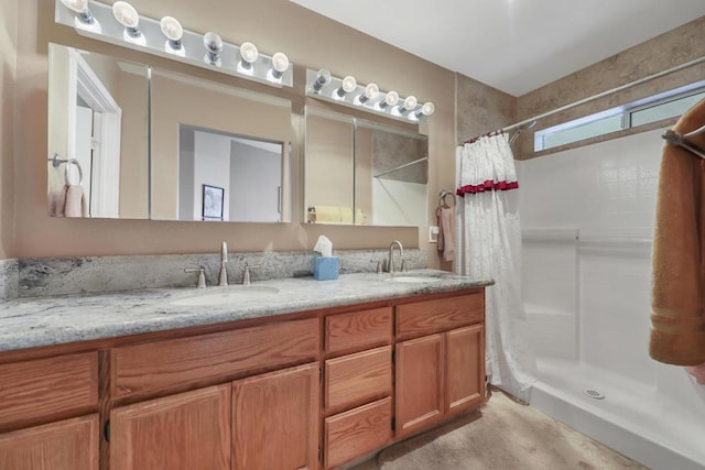 bathroom featuring walk in shower and vanity