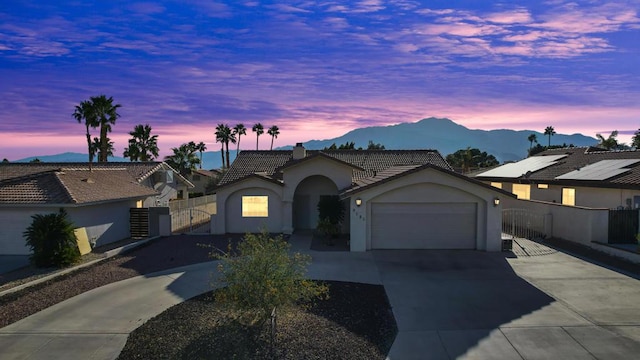 view of front of property with a mountain view and a garage