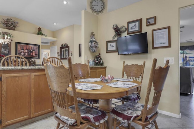 dining room featuring lofted ceiling and a chandelier