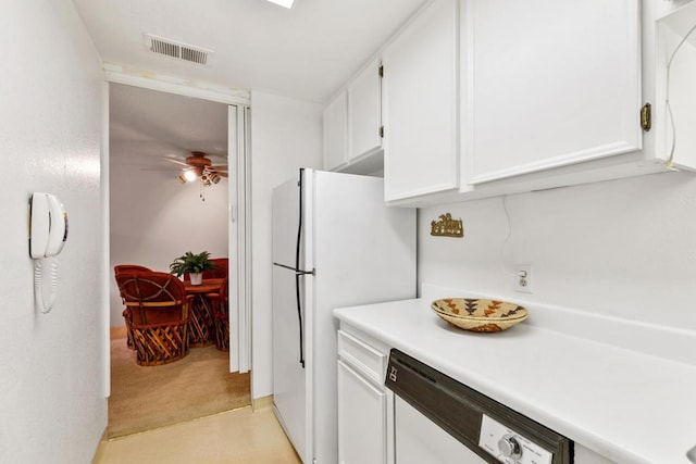 kitchen featuring white cabinetry, ceiling fan, light carpet, and white appliances