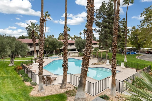 view of pool featuring a yard and a patio