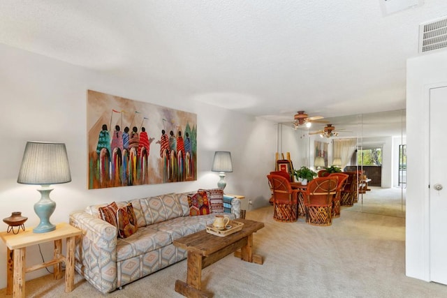 living room featuring ceiling fan and light colored carpet