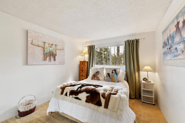 bedroom with light carpet and a textured ceiling