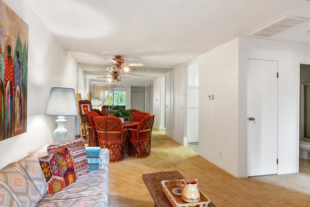 living room featuring ceiling fan and light colored carpet