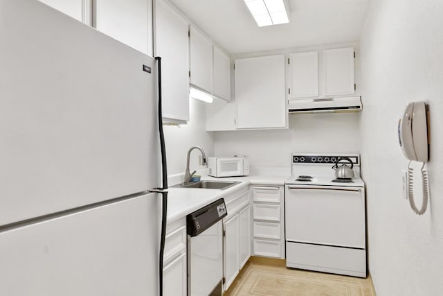 kitchen with white appliances, white cabinetry, and sink