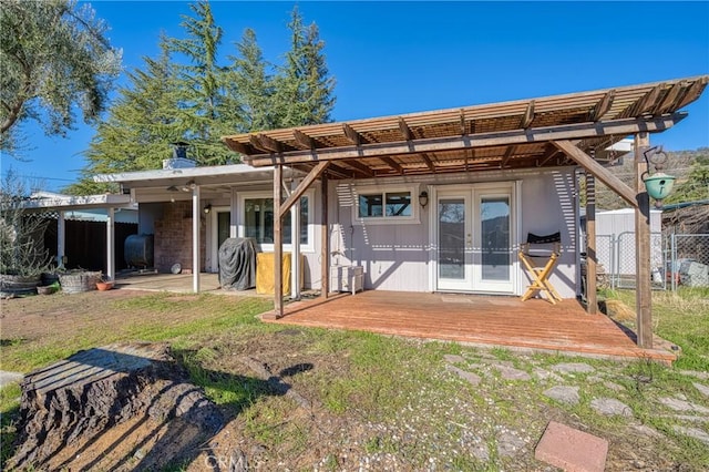 rear view of house with french doors and a wooden deck