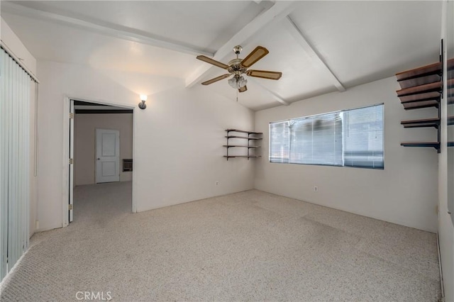 carpeted spare room with ceiling fan and vaulted ceiling with beams