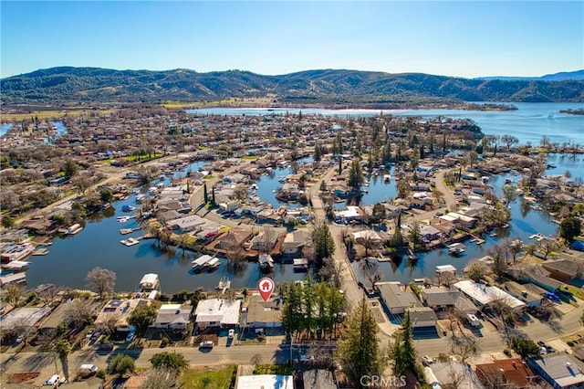 aerial view featuring a water and mountain view