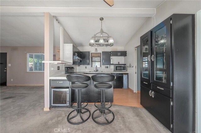 kitchen with black appliances, decorative light fixtures, a kitchen bar, decorative backsplash, and lofted ceiling with beams