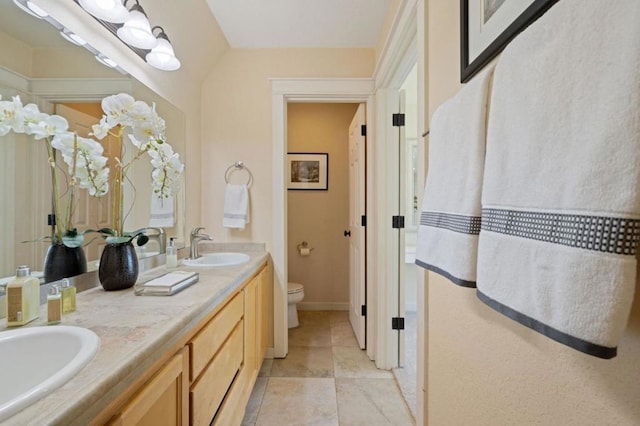 bathroom with toilet and vanity