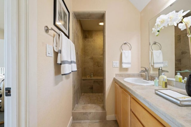 bathroom with vanity, tile patterned floors, and tiled shower