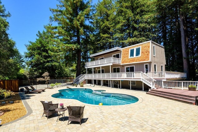 view of pool featuring a patio area and a deck