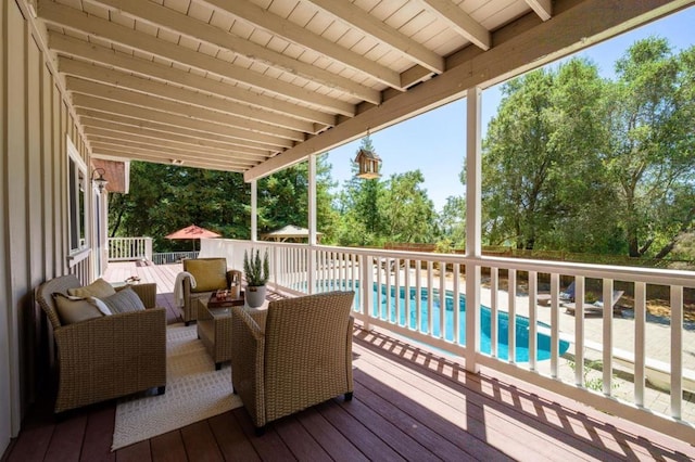 deck with outdoor lounge area and a fenced in pool