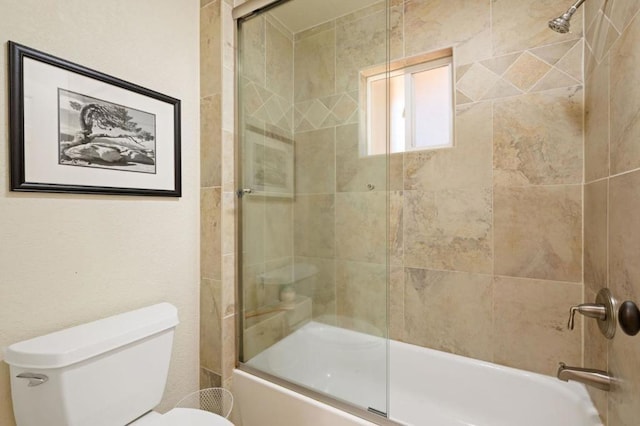 bathroom featuring toilet and enclosed tub / shower combo