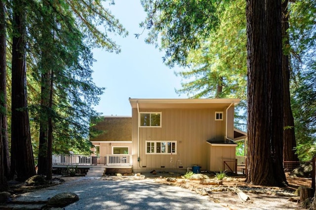 back of house featuring a deck