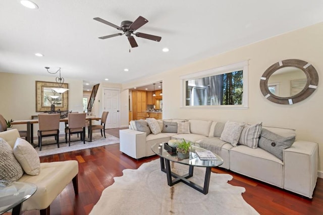 living room featuring ceiling fan and dark hardwood / wood-style flooring