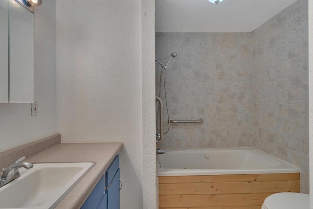 full bathroom featuring toilet, vanity, and tiled shower / bath