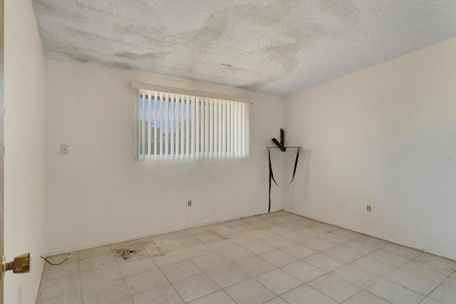 unfurnished room featuring a textured ceiling