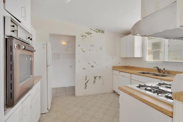 kitchen featuring sink, white appliances, white cabinets, and extractor fan