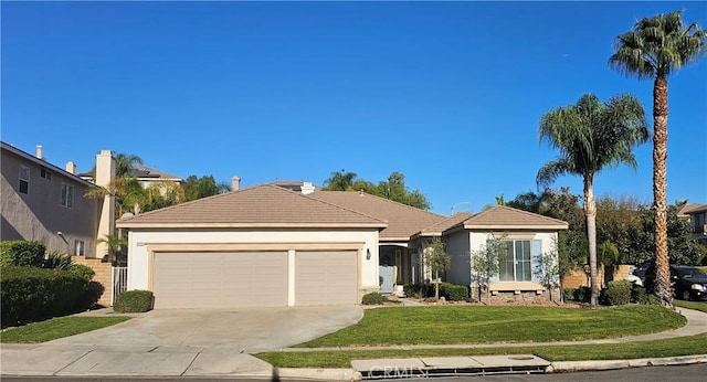 single story home featuring a garage and a front yard