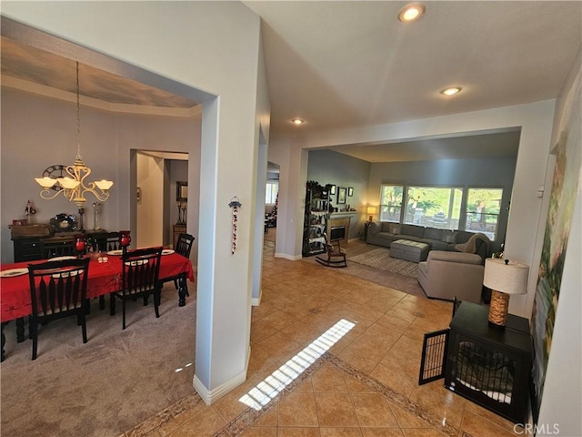 tiled living room with a chandelier and a tray ceiling