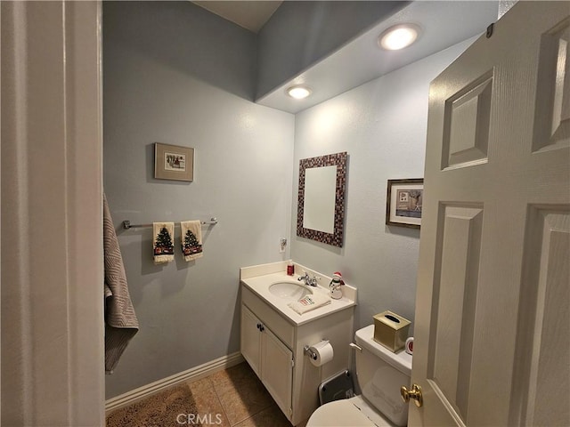 bathroom featuring toilet, vanity, and tile patterned flooring