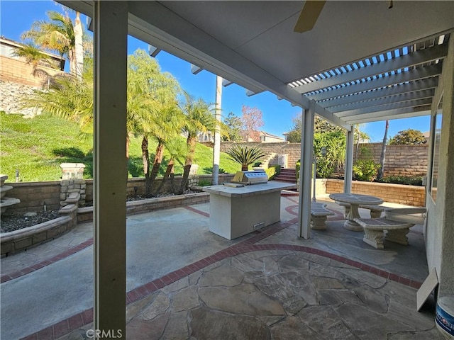 view of patio featuring ceiling fan and an outdoor kitchen